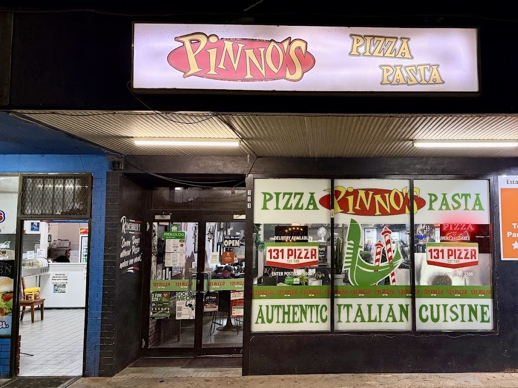 Pinno's Pizza & Pasta shopfront lit up on Deakin Avenue, Mildura, at night